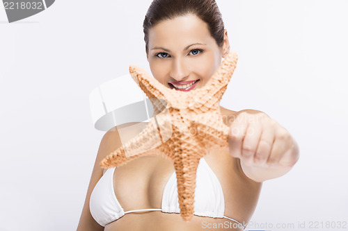 Image of Beautiful woman holding a starfish