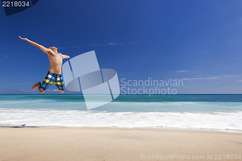 Image of Man jumping on the beach