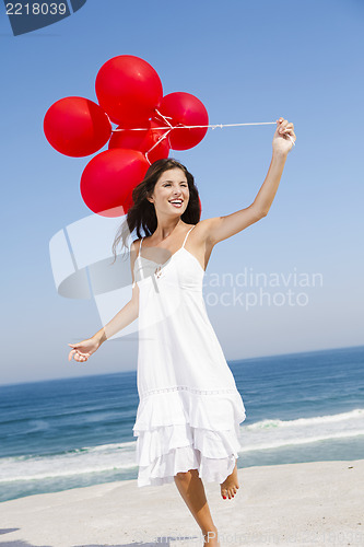 Image of Beautiful girl holding red ballons