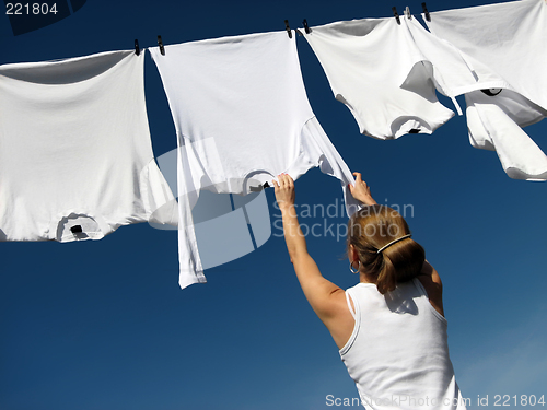 Image of Girl, blue sky and white laundry