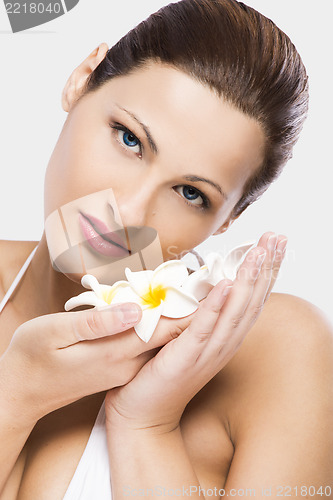 Image of Beautiful woman holding flowers