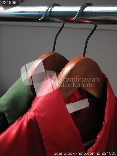 Image of Red and green shirts in a closet