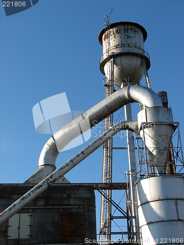 Image of Factory building with water tower and metal pipes