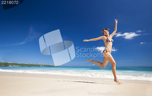 Image of Woman jumping on the beach
