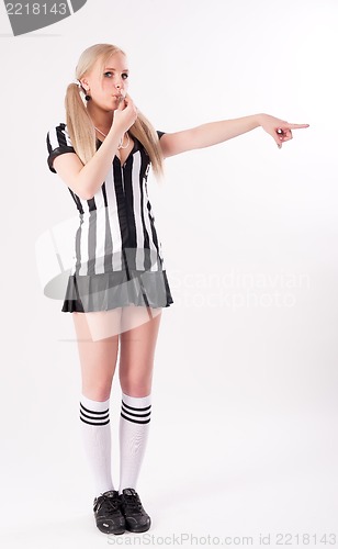 Image of Football referee whistling and pointing to side