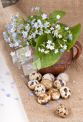 Image of quail eggs and forget-me-not flowers