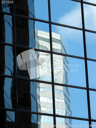 Image of Corporate tower reflecting another office building and the sky