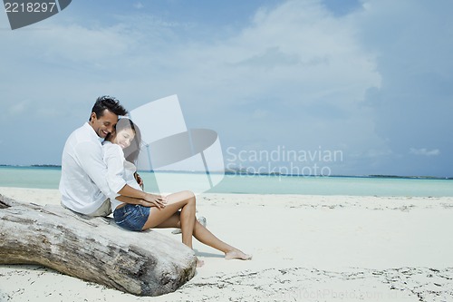 Image of Couple romancing on the beach