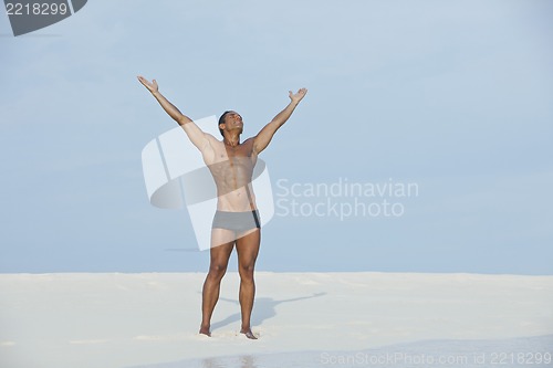 Image of Man standing with his arm outstretched