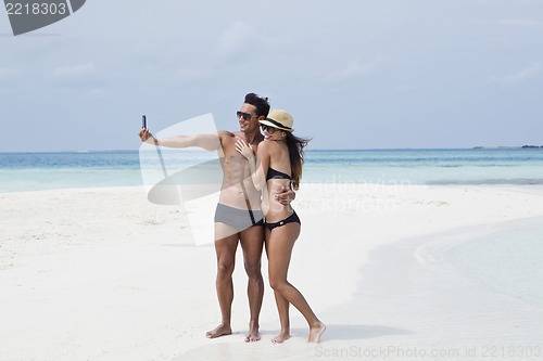 Image of Couple taking a picture of themselves on the beach