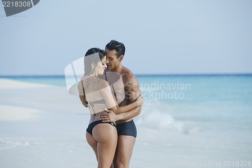 Image of Couple romancing on the beach