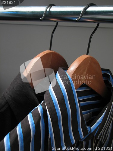 Image of Two stylish shirts on wooden hangers