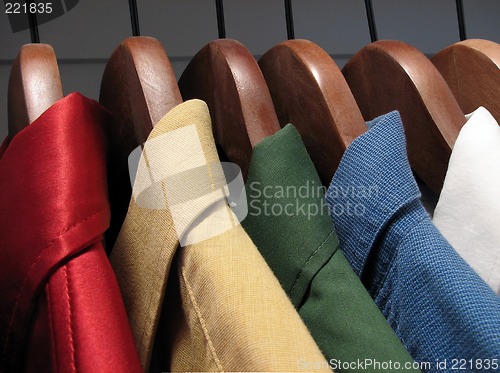 Image of Colorful shirts on wooden hangers