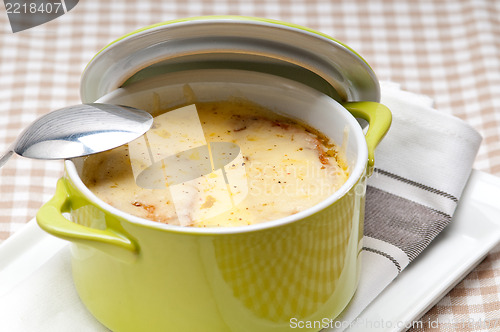 Image of onion soup with melted cheese and bread on top