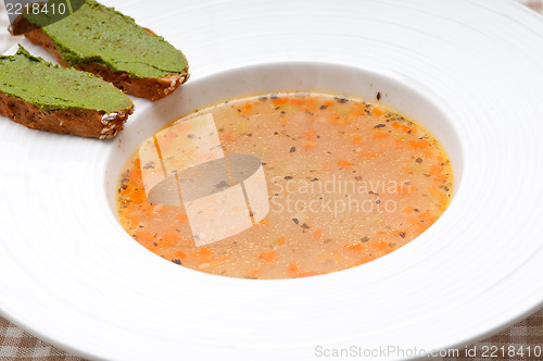 Image of Italian minestrone soup with pesto crostini on side