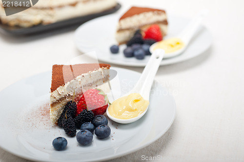 Image of tiramisu dessert with berries and cream