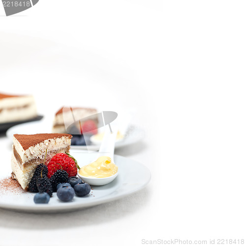 Image of tiramisu dessert with berries and cream