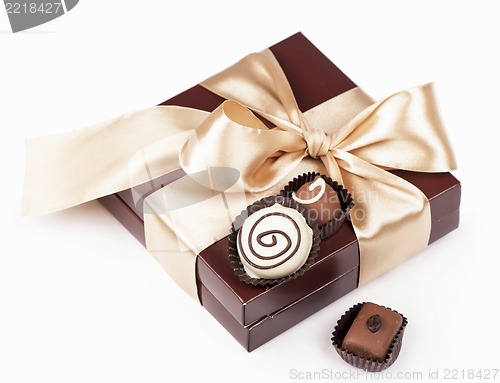 Image of brown box with candies and golden tape