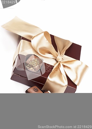 Image of brown box with candies and golden tape