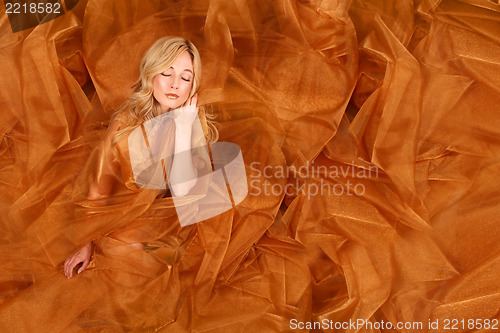 Image of Woman Wrapped in Copper Flowing Fabric