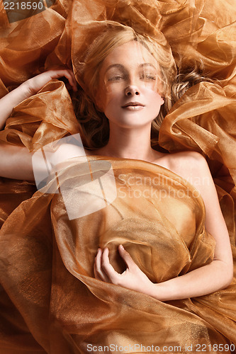 Image of Woman Wrapped in Copper Flowing Fabric