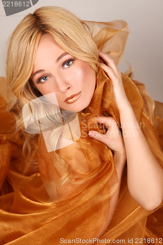 Image of Woman Wrapped in Copper Flowing Fabric