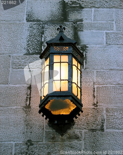 Image of Vintage lantern on a stone wall of an old building