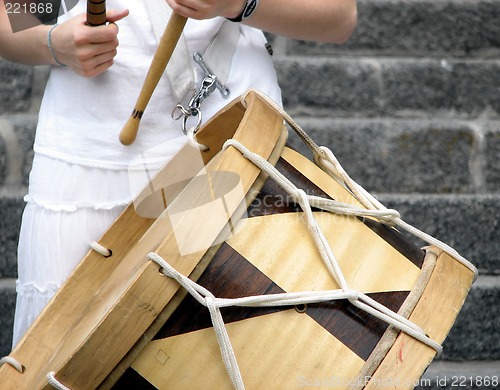 Image of Girl playing Brazilian alfaia drum