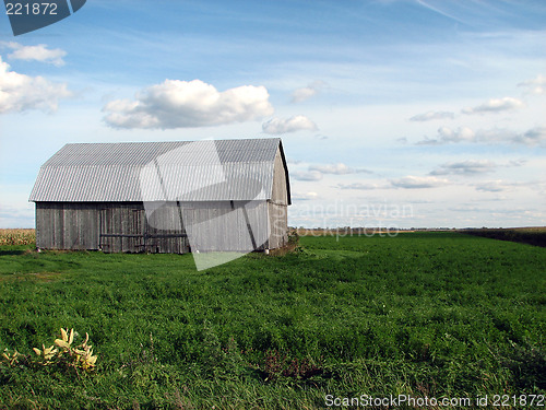 Image of Old wooden barn in the green field