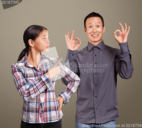 Image of Asian Man and Girl Showing OK