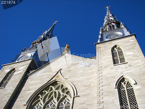 Image of Notre Dame Basilica against the bright blue sky