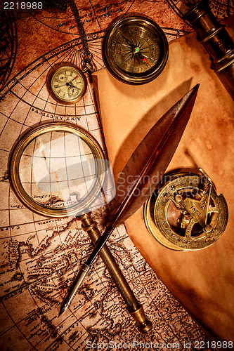 Image of Vintage magnifying glass lies on an ancient world map