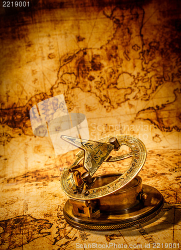 Image of Vintage compass lies on an ancient world map.