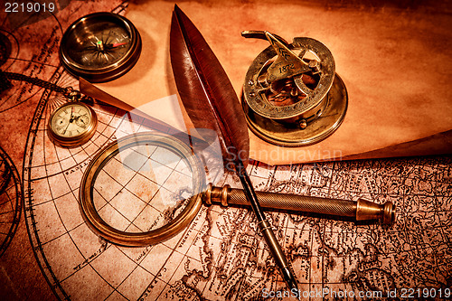 Image of Vintage magnifying glass lies on an ancient world map