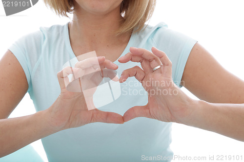 Image of Woman making a heart gesture with her fingers