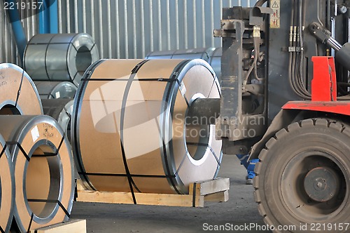 Image of Forklift with rolls of steel sheet