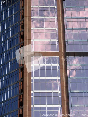 Image of Glass-windowed corporate building reflecting the sky