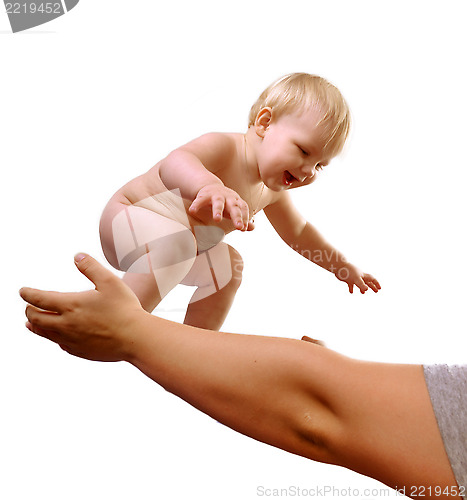 Image of toddler boy smiling in mom's hands