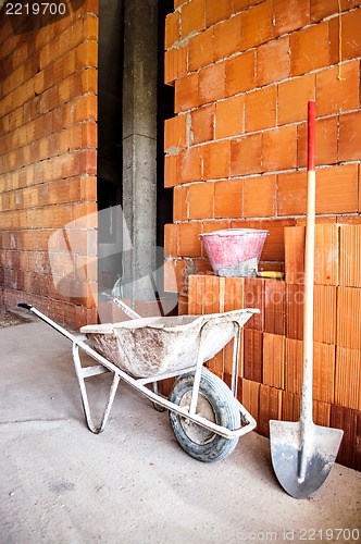 Image of masonry, wheelbarrow, bricks and shovel