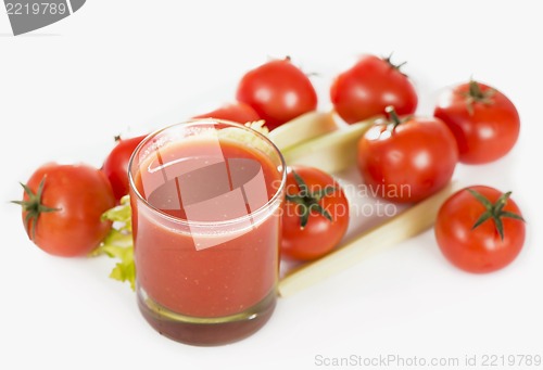 Image of Glass of tomato juice and tomatoes on a white background