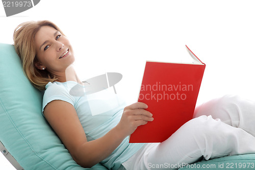 Image of Woman relaxing reading a book