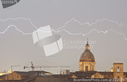 Image of Parallel lightning over urban houses