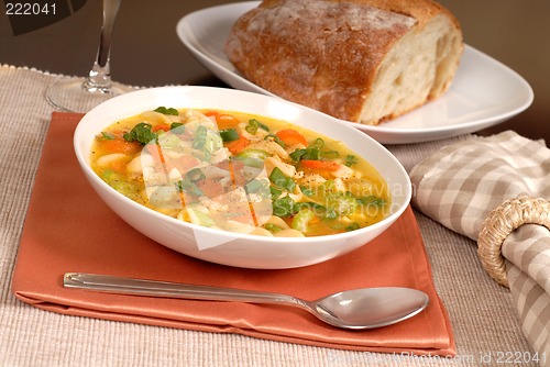 Image of Bowl of chicken noodle soup with rustic bread