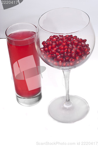 Image of fresh grains and juice pomegranate in glass