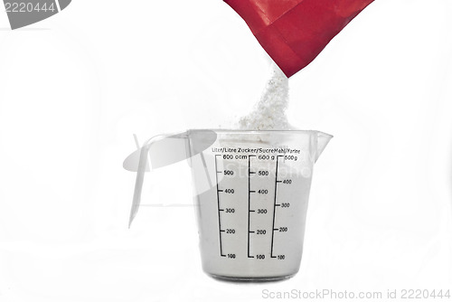 Image of Pouring flour on Kitchen measuring cup