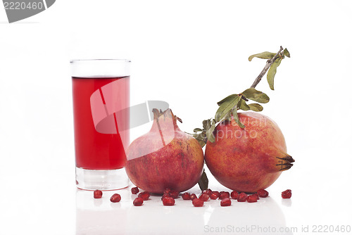 Image of fresh ripe pomegranate and juice in the glass