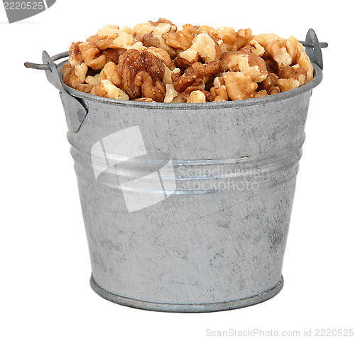 Image of Chopped walnuts in a miniature metal bucket