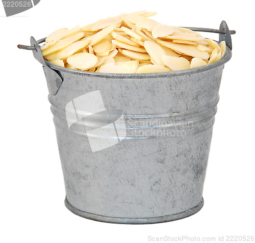 Image of Flaked almonds in a miniature metal bucket