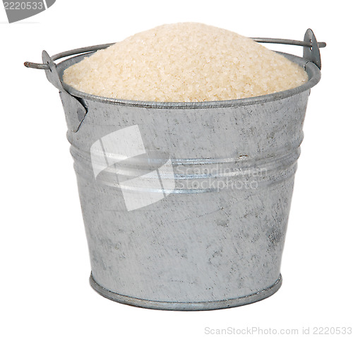 Image of Golden granulated sugar in a miniature metal bucket