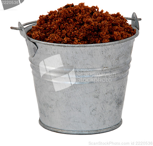 Image of Dark brown soft / muscovado sugar in a miniature metal bucket